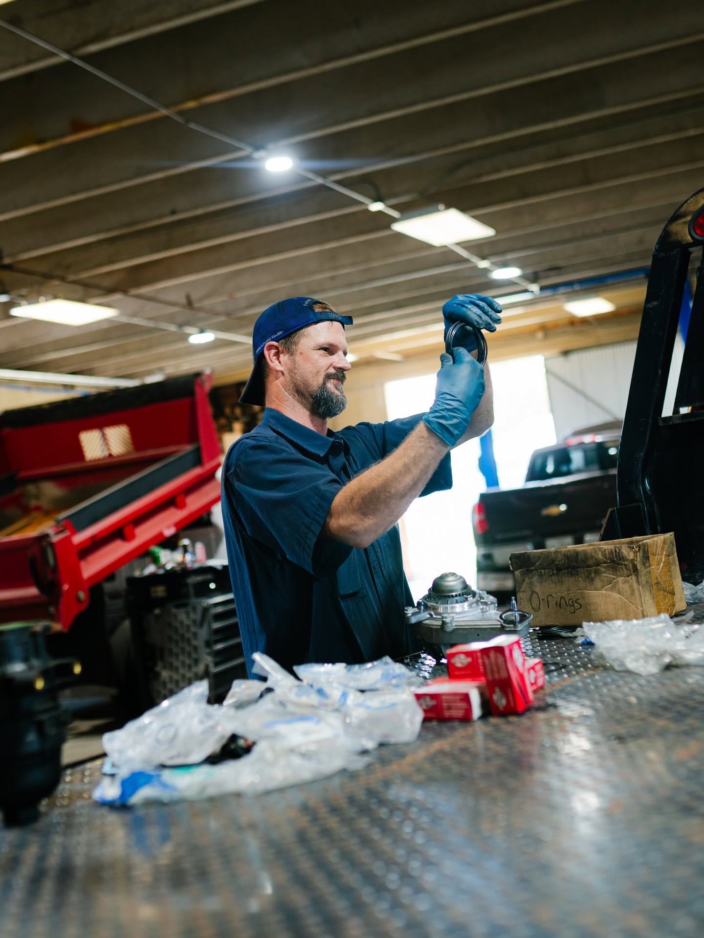 Tech inspecting a water pump rebuild