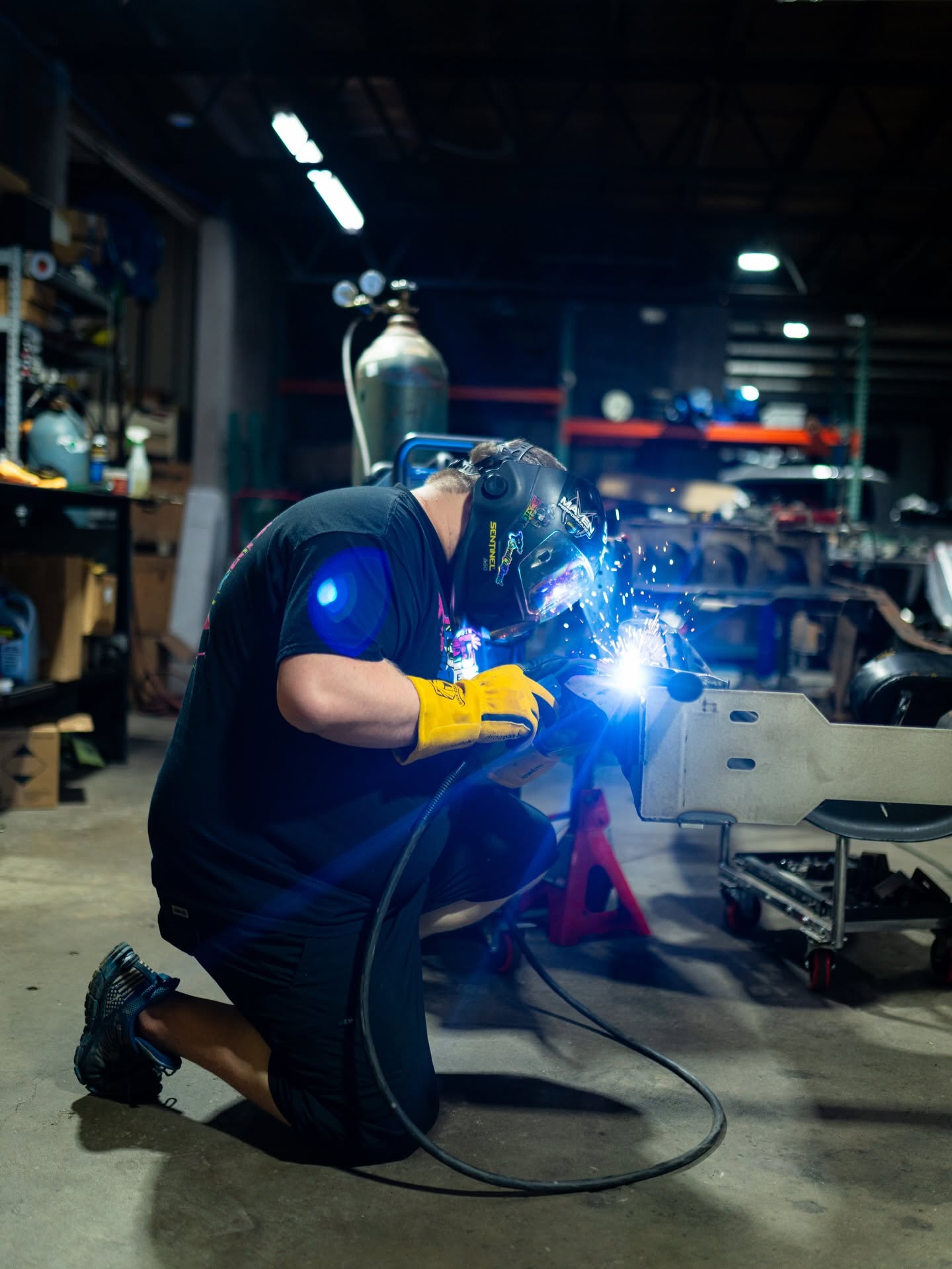 MIG welding a bracket in the shop